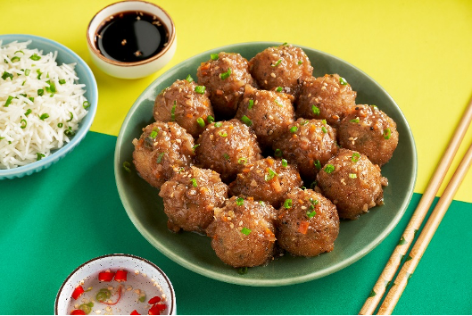 Goeld Manchurian balls with dip sauce and chopstick